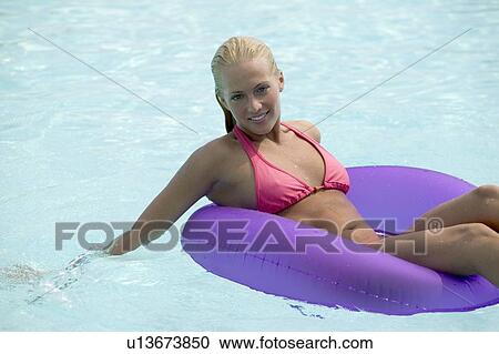 Stock Image - Young woman in a swimming pool. Fotosearch