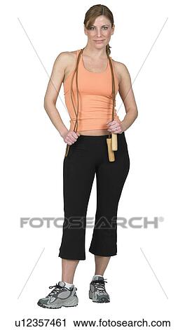 Stock Image - Young woman preparing to jump rope. Fotosearch
