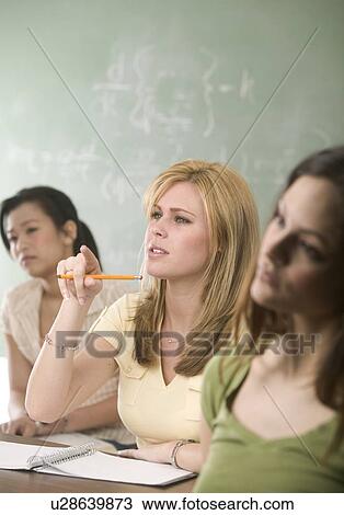 Young women in a college classroom View Large Photo Image Stock Image - Young women in a college classroom. Fotosearch