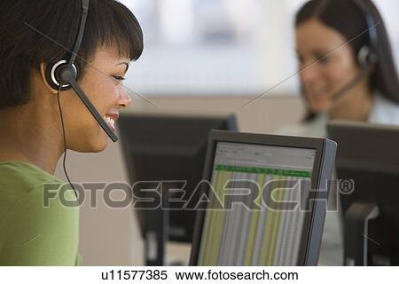 Stock Photography - African businesswoman wearing headset. Fotosearch