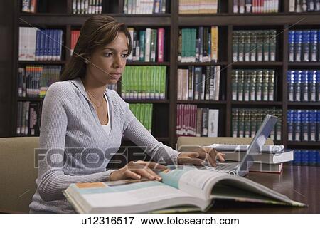African female college student studying in library View Large Photo Image Stock Photo - African female college student studying in library. Fotosearch