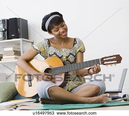 African woman playing acoustic guitar View Large Photo Image Stock Image - African woman playing acoustic guitar. Fotosearch