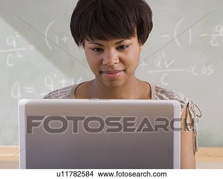 African woman using laptop in classroom View Large Photo Image Picture - African woman using laptop in classroom. Fotosearch