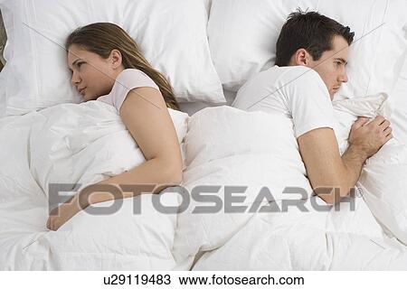 Angry couple laying in bed View Large Photo Image Stock Image - Angry couple laying in bed. Fotosearch