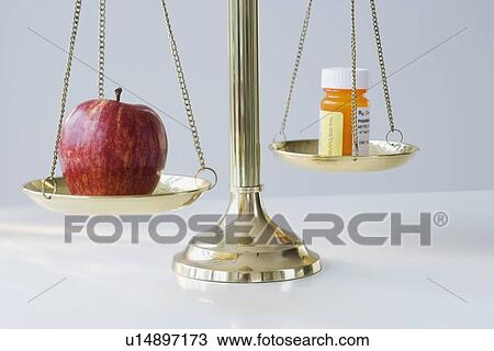 Apple and medication on scales View Large Photo Image Stock Image - Apple and medication on scales. Fotosearch