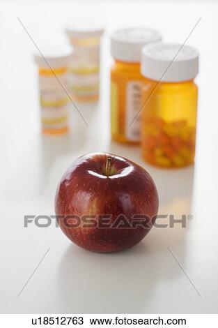 Apple in front of medication bottles View Large Photo Image Stock Image - Apple in front of medication bottles. Fotosearch