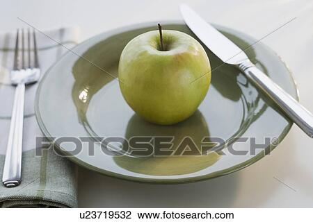 Stock Image - Apple on plate. Fotosearch