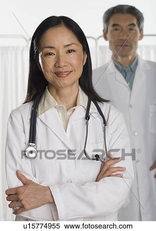 Stock Photography - Asian female and male doctors smiling. Fotosearch
