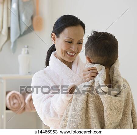 Stock Image - Asian mother drying son with towel. Fotosearch
