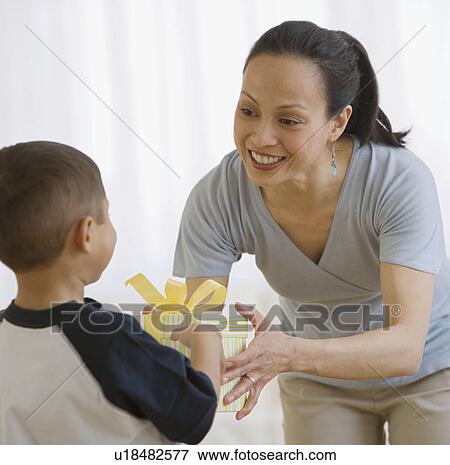Stock Photo - Asian mother receiving gift from son. Fotosearch