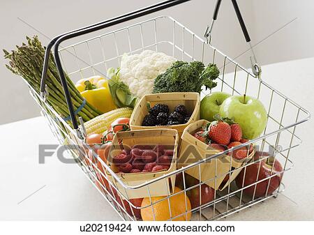 Picture - Assorted fruits and vegetables in shopping basket. Fotosearch