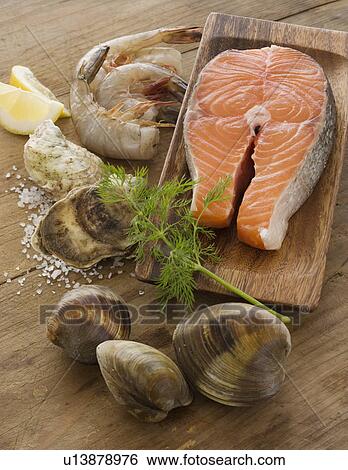 Assorted seafood on table View Large Photo Image Stock Photograph - Assorted seafood on table. Fotosearch