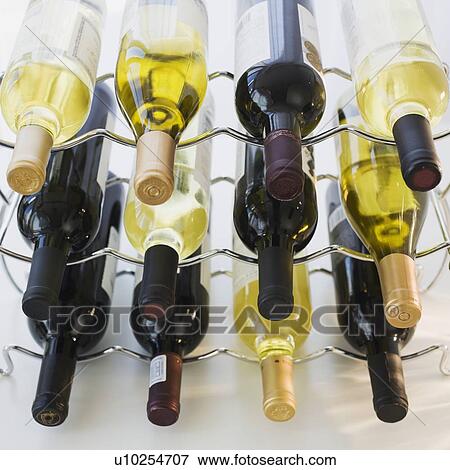Stock Photo - Assorted wine bottles on wine rack. Fotosearch