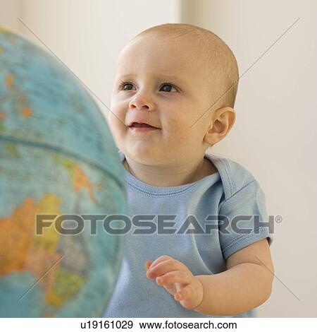 Baby looking at globe View Large Photo Image Stock Photo - Baby looking at globe. Fotosearch