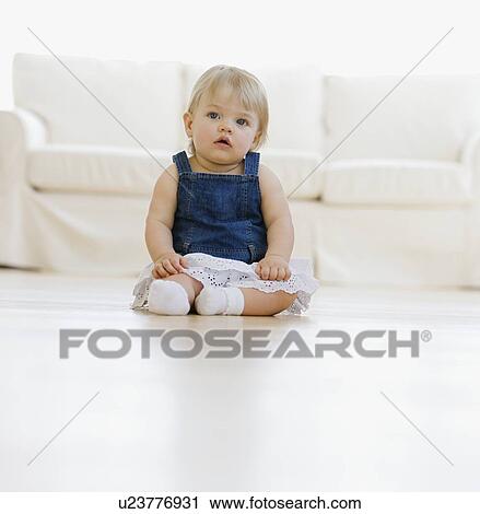 Baby sitting on floor View Large Photo Image Stock Image - Baby sitting on floor. Fotosearch
