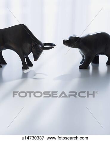 Stock Photo - Bear and bull figurines facing each other. Fotosearch