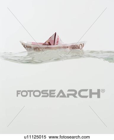 Boat made of paper money floating on water View Large Photo Image Stock Photography - Boat made of paper money floating on water. Fotosearch