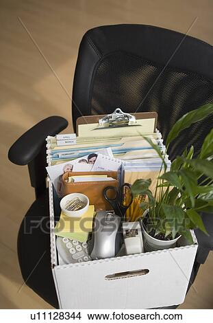 Box of office items on chair View Large Photo Image Picture - Box of office items on chair. Fotosearch