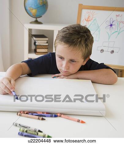Boy coloring at table View Large Photo Image Stock Photo - Boy coloring at table. Fotosearch