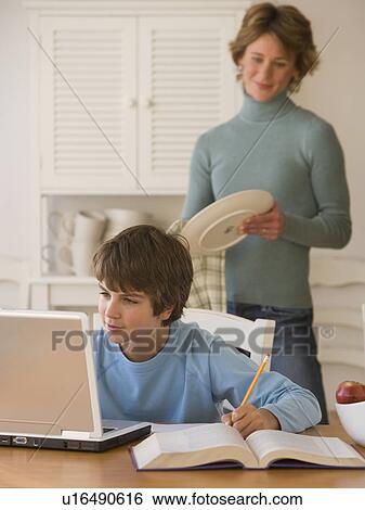 Boy doing homework with laptop View Large Photo Image Stock Photograph - Boy doing homework with laptop. Fotosearch
