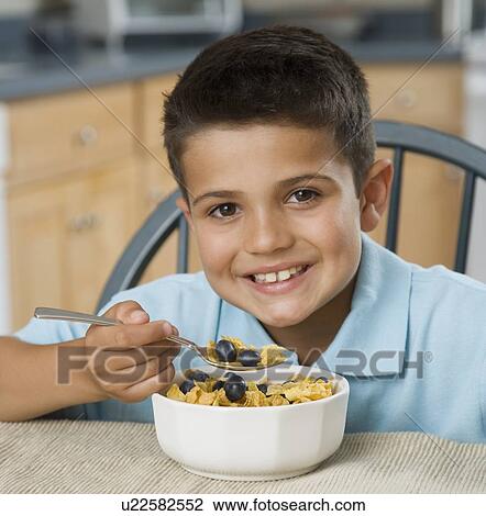 Boy eating cereal View Large Photo Image Stock Image - Boy eating cereal. Fotosearch