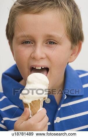 Stock Photo - Boy eating ice cream cone. Fotosearch