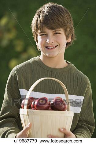 Boy holding basket of apples View Large Photo Image Stock Photo - Boy holding basket of apples. Fotosearch