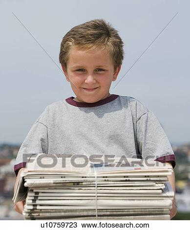 Boy holding stack of bundled newspapers View Large Photo Image Stock Image - Boy holding stack of bundled newspapers. Fotosearch
