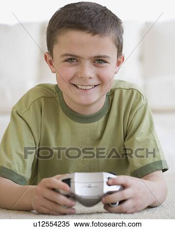 Stock Photography - Boy holding video game controller. Fotosearch