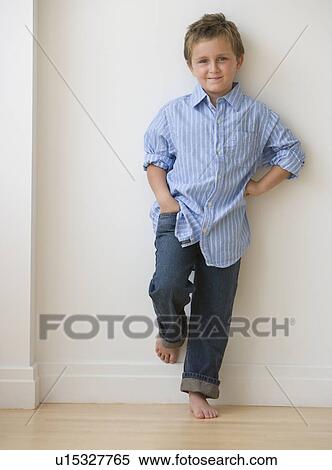 Boy leaning against wall View Large Photo Image Stock Photography - Boy leaning against wall. Fotosearch