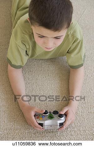 Boy playing video games View Large Photo Image Stock Photograph - Boy playing video games. Fotosearch