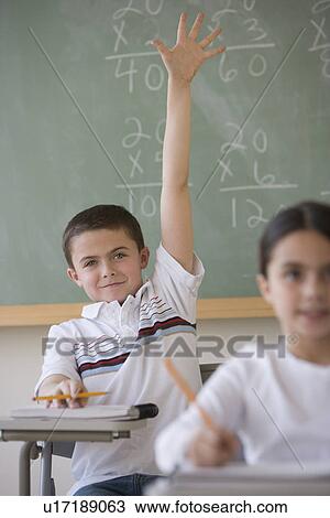 Boy raising hand in classroom View Large Photo Image Stock Image - Boy raising hand in classroom. Fotosearch