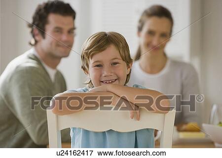 Boy sitting backwards in chair View Large Photo Image Stock Photo - Boy sitting backwards in chair. Fotosearch