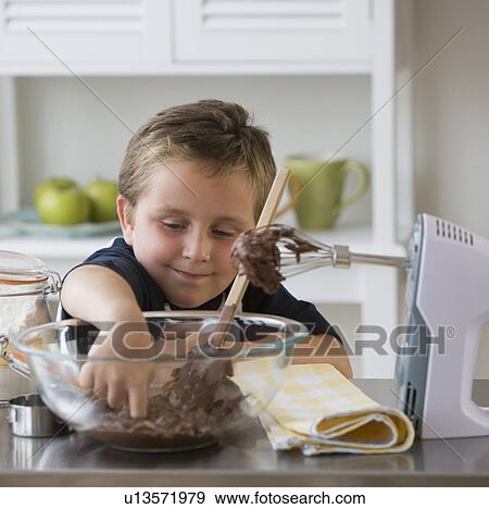 Boy sticking finger into bowl of batter View Large Photo Image Stock Photo - Boy sticking finger into bowl of batter. Fotosearch