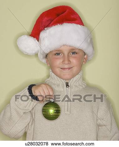 Boy wearing Santa Claus hat View Large Photo Image Stock Photo - Boy wearing Santa Claus hat. Fotosearch