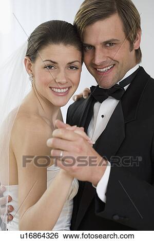 Stock Photograph - Bride and groom dancing. Fotosearch