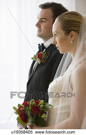 Bride and groom standing next to each other View Large Photo Image Stock Photography - Bride and groom standing next to each other. Fotosearch