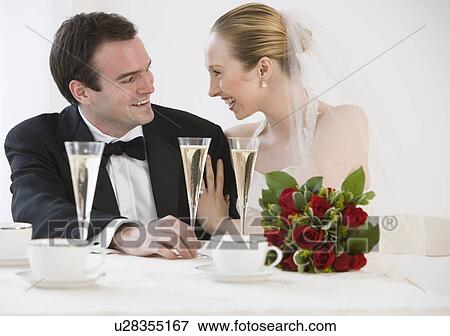 Bride and groom with champagne View Large Photo Image Stock Photo - Bride and groom with champagne. Fotosearch