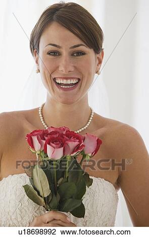 Bride holding bouquet of flowers View Large Photo Image Stock Image - Bride holding bouquet of flowers. Fotosearch