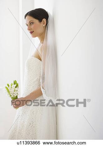 Bride leaning on wall View Large Photo Image Stock Photograph - Bride leaning on wall. Fotosearch