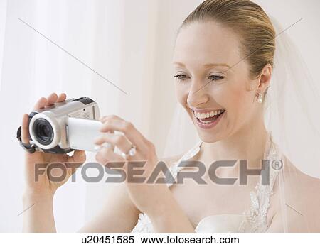 Stock Photography - Bride using video camera. Fotosearch