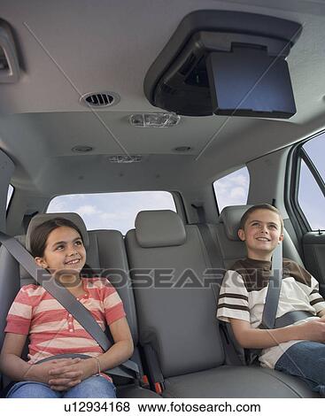 Brother and sister watching moving in car View Large Photo Image Stock Photo - Brother and sister watching moving in car. Fotosearch
