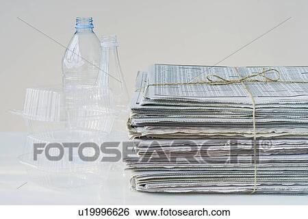 Stock Photograph - Bundled newspapers and plastic for recycling. Fotosearch