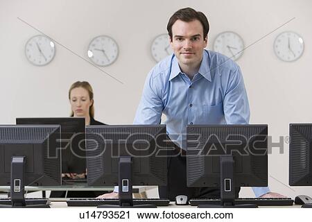 Businessman behind row of computers View Large Photo Image Stock Image - Businessman behind row of computers. Fotosearch
