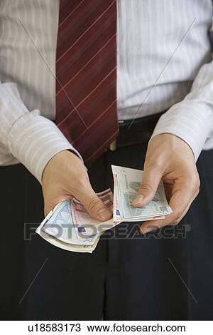 Businessman counting Euro banknotes View Large Photo Image Stock Image - Businessman counting Euro banknotes. Fotosearch