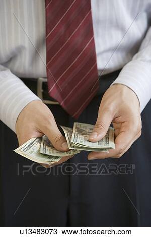 Businessman counting US Dollars View Large Photo Image Stock Image - Businessman counting US Dollars. Fotosearch