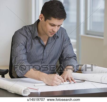 Stock Photo - Businessman drawing on blueprints. Fotosearch