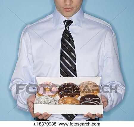 Businessman holding box of donut View Large Photo Image Stock Photo - Businessman holding box of donut. Fotosearch