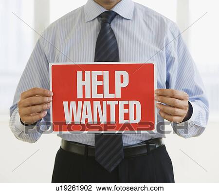 Businessman holding Help Wanted sign View Large Photo Image Stock Image - Businessman holding Help Wanted sign. Fotosearch