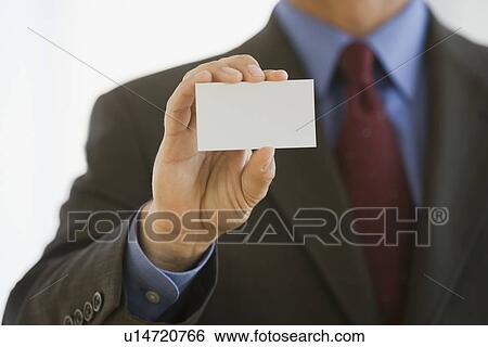 Businessman holding up business card View Large Photo Image Stock Photograph - Businessman holding up business card. Fotosearch